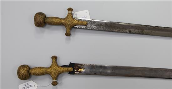 A near pair of Indian sword tulwars, late 19th century, L 81cm (blade)